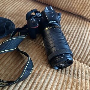 Nikon Black DSLR with Long Zoom Lens
